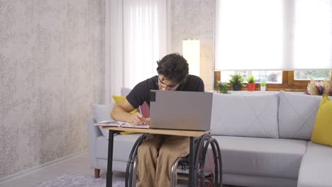 Disabled-student-working-with-laptop-at-home.